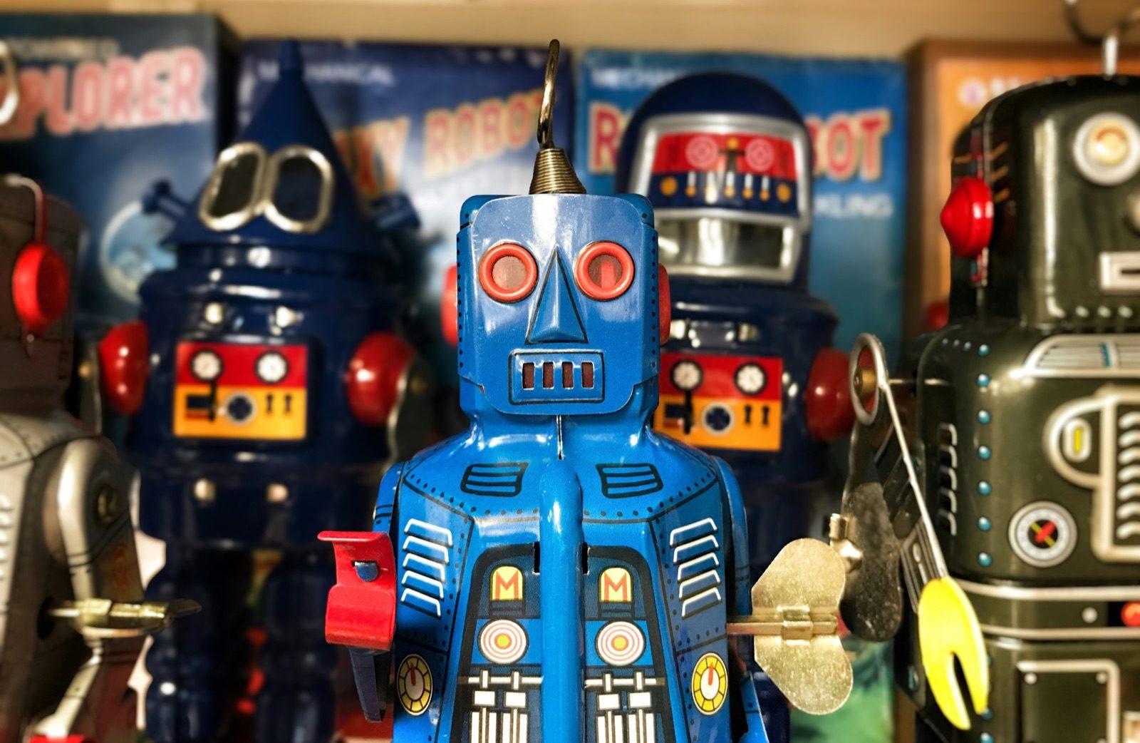 A shelf of vintage tin wind-up robots